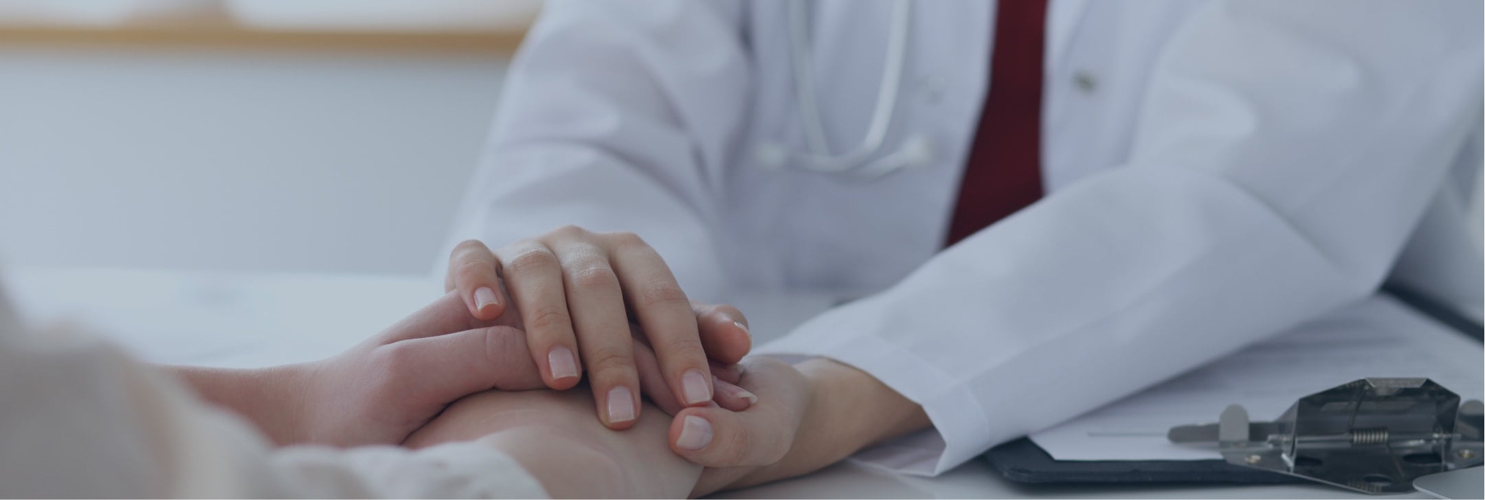 doctor holding patients hand