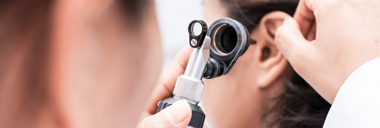 primary care doctor checking ear