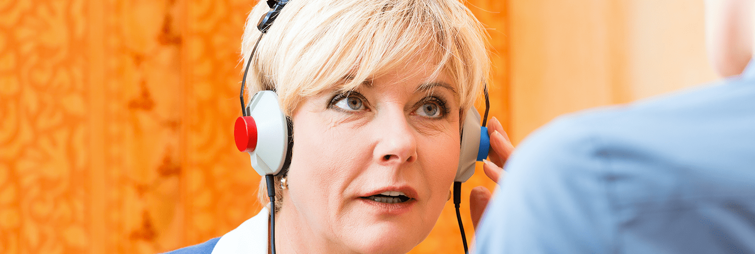 woman taking hearing exam