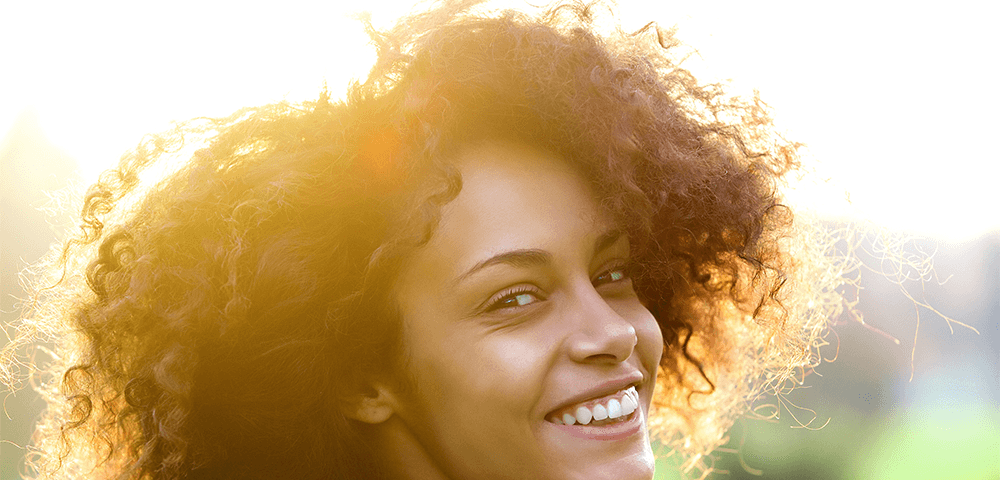 happy woman smiling in the sun