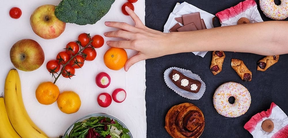 hand reaching for healthy alternative to stress eating junk food