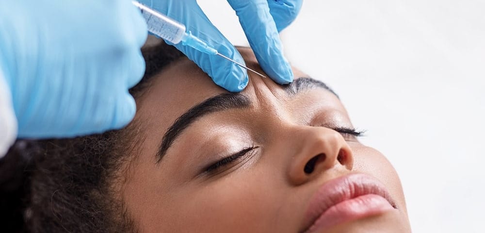 woman receiving botox treatment between eyebrows in indianapolis, in