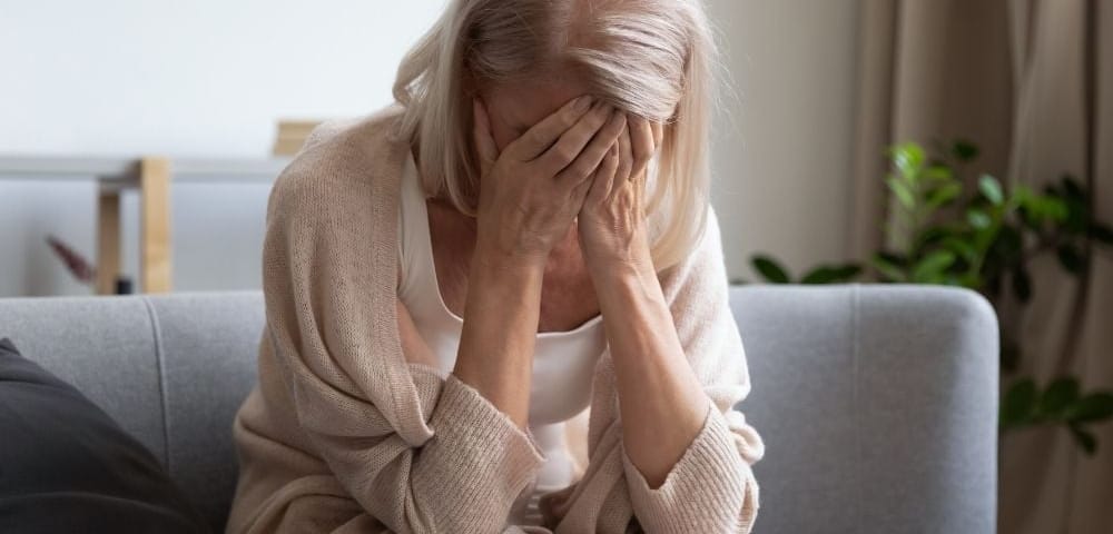 older woman suffers through the symptoms of hormone imbalance