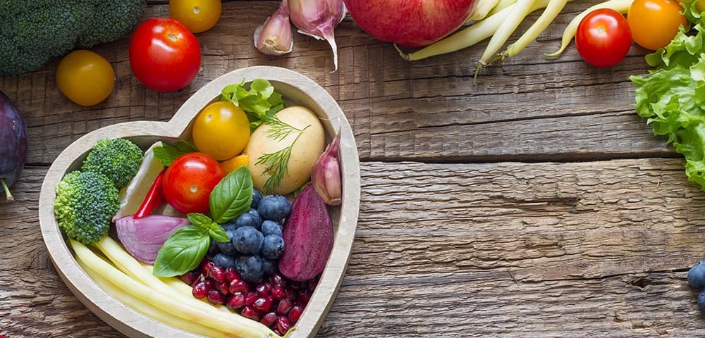 foods that support heart health in a heart shaped bowl