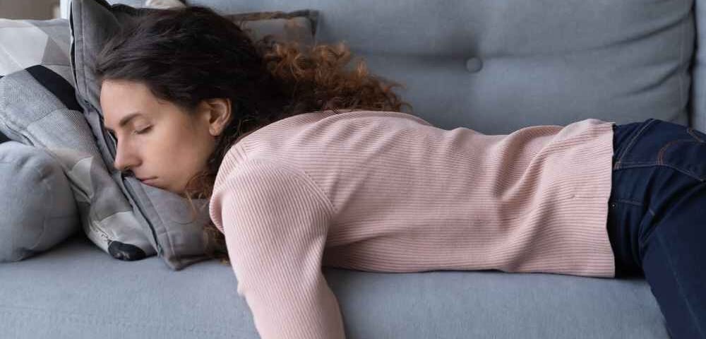 woman laying on couch displaying signs of low iron