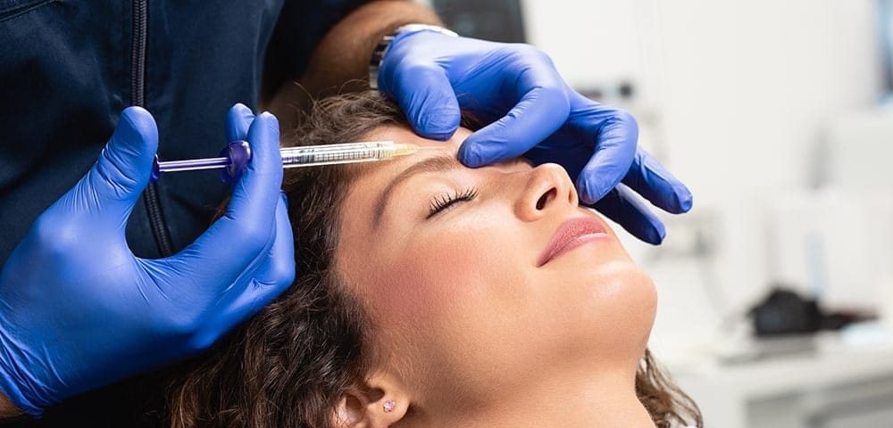 woman receiving forehead Botox at the doctor's office