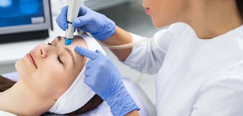 healthcare professional using hydrodermabrasion machine