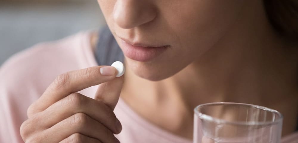 a woman taking medicine