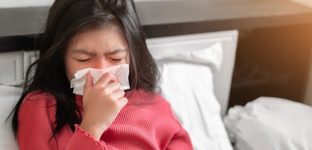A girl sneezing