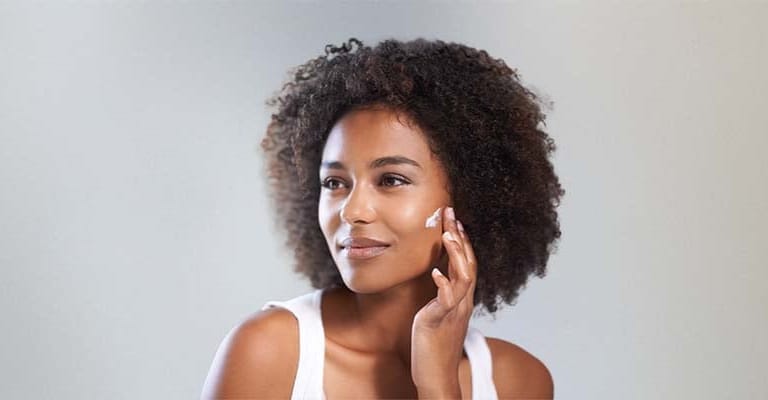 a woman applying face cream