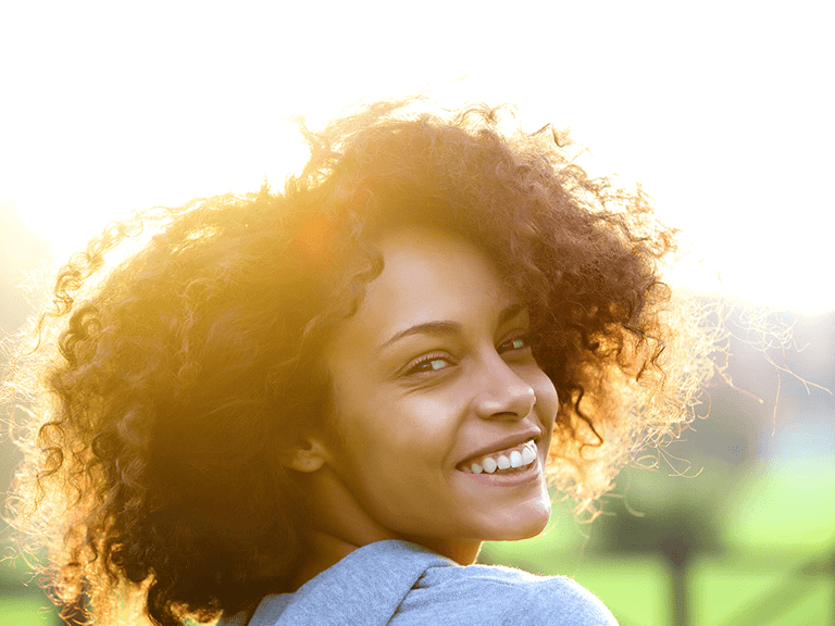 happy woman smiling in the sun