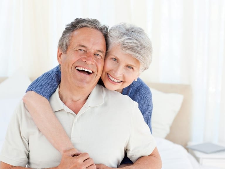 woman holds onto man who is dealing with erectile dysfunction