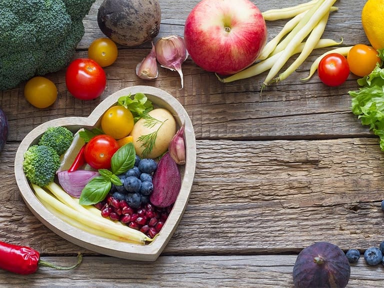 foods that support heart health in a heart shaped bowl