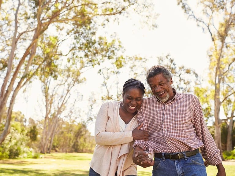 older couple strolling in park together