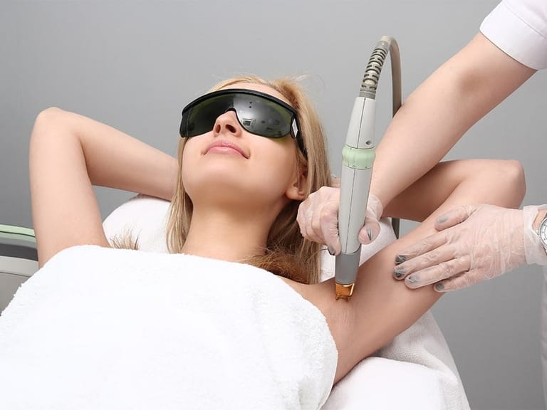 woman receiving laser hair removal treatment on underarms