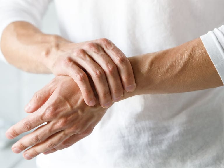 close up of woman dealing with chronic pain in her wrists