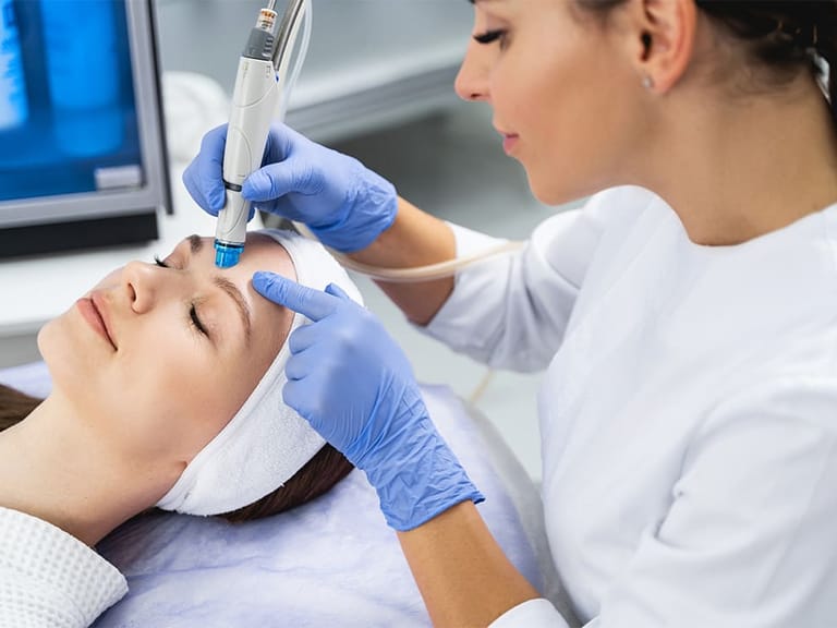 healthcare professional using hydrodermabrasion machine