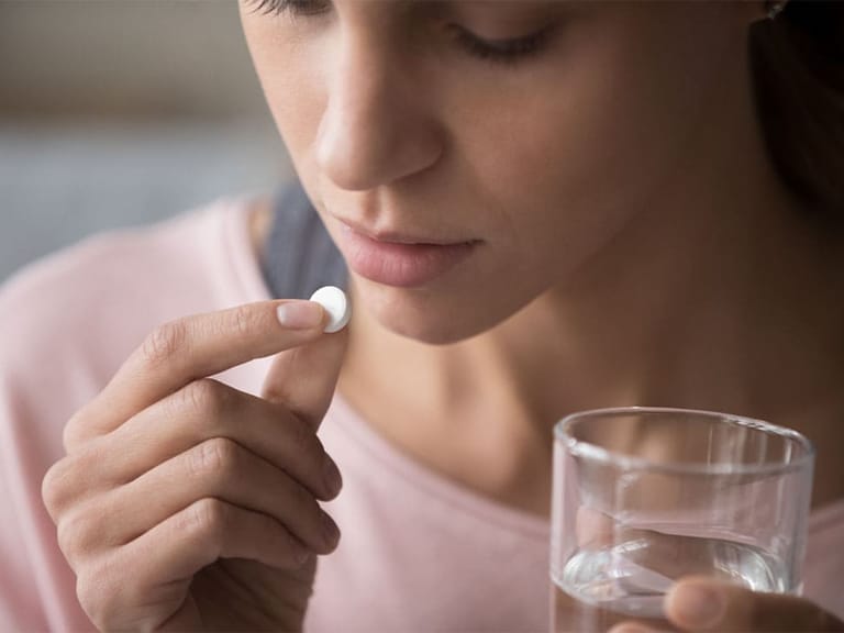 a woman taking medicine