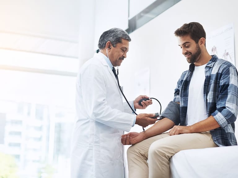 a doctor checking a patient's blood pressure