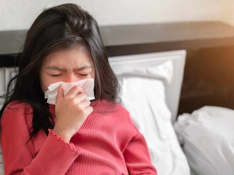 A girl sneezing
