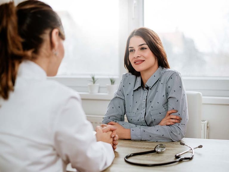 A woman speaking with a concierge doctor