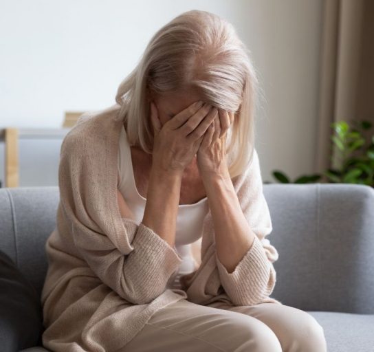older woman suffers through the symptoms of hormone imbalance
