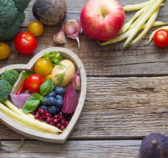 foods that support heart health in a heart shaped bowl