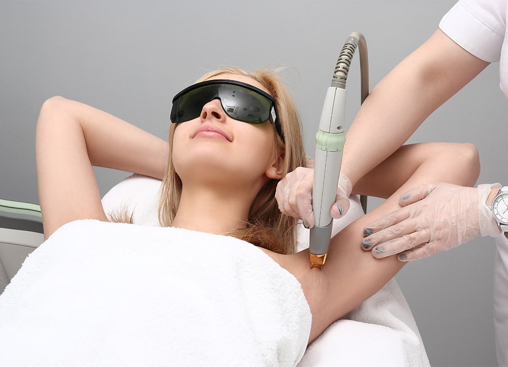 woman receiving laser hair removal treatment on underarms